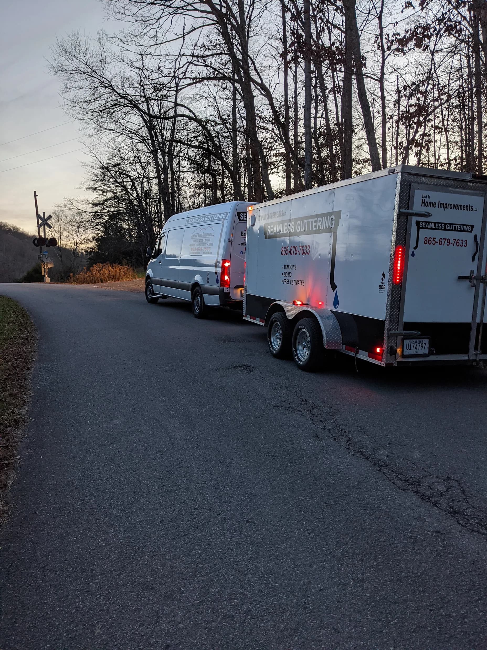 East TN Home Improvements van and gutter trailer arriving at a job site