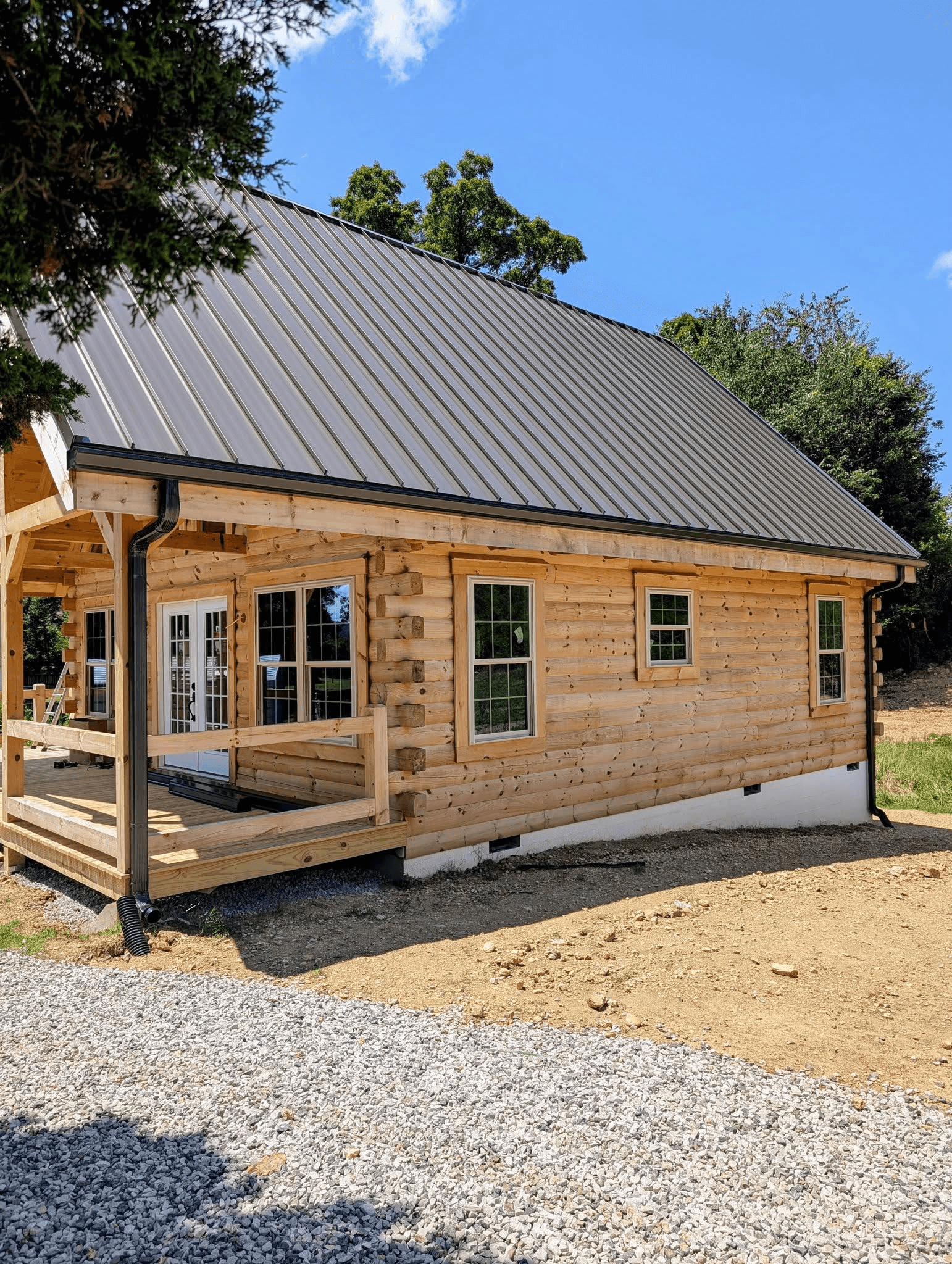 Seamless gutters and downspouts installed on a log home